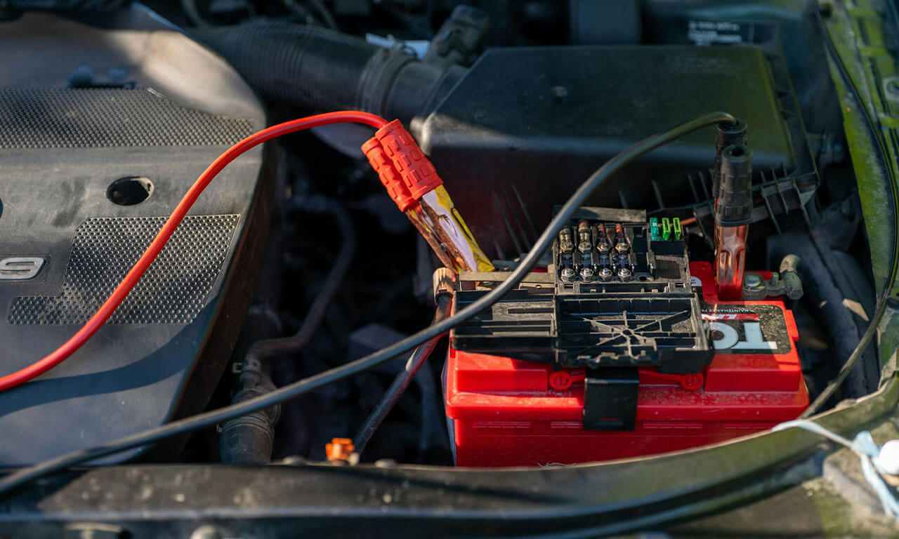 Car Battery with Jumper Cables Attached